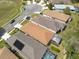 An aerial view shows the neighborhood homes with screen enclosed patios and well-manicured landscaping at 5664 Legend Hills Ln, Spring Hill, FL 34609