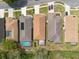 An aerial view highlights the pool and patio features of the homes within a well-maintained neighborhood at 5664 Legend Hills Ln, Spring Hill, FL 34609