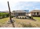 View of the home's backyard and screened-in patio area at 5664 Legend Hills Ln, Spring Hill, FL 34609