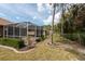 Wide shot of the screened in back patio and manicured backyard space at 5664 Legend Hills Ln, Spring Hill, FL 34609