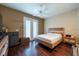 Well-lit bedroom with hardwood floors and a modern ceiling fan at 5664 Legend Hills Ln, Spring Hill, FL 34609