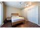 Modern bedroom with hardwood floors, a cozy bed, and ample natural light from the window at 5664 Legend Hills Ln, Spring Hill, FL 34609