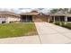 Charming home with a two-car garage and well-maintained front yard at 5664 Legend Hills Ln, Spring Hill, FL 34609