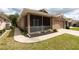Charming house with a screened-in porch, manicured lawn, and a paved walkway to the front door at 5664 Legend Hills Ln, Spring Hill, FL 34609