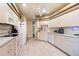 Bright kitchen featuring modern appliances, light wood cabinetry, and ample counter space at 5664 Legend Hills Ln, Spring Hill, FL 34609