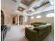 Open living area with decorative ceiling, carpeted floors and plenty of natural light at 5664 Legend Hills Ln, Spring Hill, FL 34609