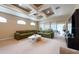 Bright and airy living room with sliding glass doors and modern ceiling fan at 5664 Legend Hills Ln, Spring Hill, FL 34609