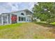 Lovely home featuring a screened lanai, balcony, and lush landscaping at 604 Mcdaniel St, Sun City Center, FL 33573