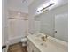 Bathroom features a shower-tub combo and sink with gold faucet at 604 Mcdaniel St, Sun City Center, FL 33573