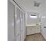 Bathroom with built-in vanity, white cabinets, and mirrored wall at 604 Mcdaniel St, Sun City Center, FL 33573