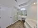 A bright, well-lit bathroom with vanity, soaking tub, walk-in shower, and neutral fixtures at 604 Mcdaniel St, Sun City Center, FL 33573