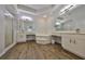 A bright, well-lit bathroom with double vanities, soaking tub, walk-in shower, and neutral fixtures at 604 Mcdaniel St, Sun City Center, FL 33573