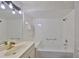 Bathroom features a shower-tub combo, bright vanity, and neutral fixtures at 604 Mcdaniel St, Sun City Center, FL 33573