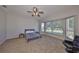 Large bedroom with a ceiling fan and expansive windows overlooking the yard at 604 Mcdaniel St, Sun City Center, FL 33573