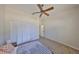 This bedroom offers neutral carpet, a ceiling fan, and a built-in closet at 604 Mcdaniel St, Sun City Center, FL 33573