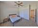 Bright bedroom with neutral carpet, ceiling fan, and closet with sliding doors at 604 Mcdaniel St, Sun City Center, FL 33573