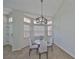 Cozy dining area with a round table and a stylish chandelier at 604 Mcdaniel St, Sun City Center, FL 33573