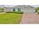 Attractive single story home with a brick driveway and a well maintained lawn at 604 Mcdaniel St, Sun City Center, FL 33573