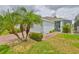 Picture of the driveway and home's exterior with lovely landscaping at 604 Mcdaniel St, Sun City Center, FL 33573