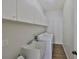 Laundry room has cabinets above a utility sink, washer, and dryer at 604 Mcdaniel St, Sun City Center, FL 33573