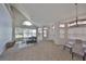 Spacious living room with vaulted ceilings, large windows, and stylish, modern furnishings at 604 Mcdaniel St, Sun City Center, FL 33573
