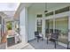 Screened patio with sliding glass doors, seating and an air conditioning unit at 604 Mcdaniel St, Sun City Center, FL 33573