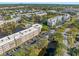 Gorgeous aerial view of the condo community featuring lake views and multiple swimming pools at 6070 80Th N St # 104, St Petersburg, FL 33709