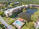 Gorgeous aerial view of the condo community featuring a swimming pool and lake views at 6070 80Th N St # 104, St Petersburg, FL 33709