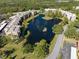 Gorgeous aerial view of the condo community featuring a lake and trees at 6070 80Th N St # 104, St Petersburg, FL 33709