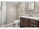 Renovated bathroom with tiled shower, modern vanity, and decorative nautical accents at 6070 80Th N St # 104, St Petersburg, FL 33709