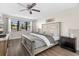 Comfortable bedroom with a large window offering a pond view and a ceiling fan at 6070 80Th N St # 104, St Petersburg, FL 33709