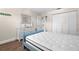 Bright bedroom featuring closet, wood-look floors, and light blue bedframe at 6070 80Th N St # 104, St Petersburg, FL 33709