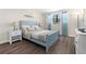 Cozy bedroom featuring a blue bed frame, wood floors, and nautical decor at 6070 80Th N St # 104, St Petersburg, FL 33709