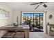 Bright dining area with sliding glass doors leading to a screened patio and pond views at 6070 80Th N St # 104, St Petersburg, FL 33709