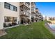Exterior view of buildings with lush green lawn and pond at 6070 80Th N St # 104, St Petersburg, FL 33709