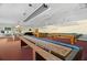 Community game room with shuffleboard and pool tables, perfect for recreational activities at 6070 80Th N St # 104, St Petersburg, FL 33709