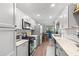 Updated kitchen featuring stainless steel appliances, granite countertops, and wood flooring at 6070 80Th N St # 104, St Petersburg, FL 33709