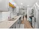 Well-lit kitchen with granite countertops, stainless appliances and hardwood flooring at 6070 80Th N St # 104, St Petersburg, FL 33709