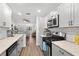 Bright kitchen featuring granite countertops, stainless appliances and hardwood flooring at 6070 80Th N St # 104, St Petersburg, FL 33709