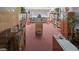 Inviting community library with bookshelves, tables, chairs, and a quiet space for reading at 6070 80Th N St # 104, St Petersburg, FL 33709