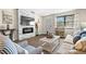 Bright living room with hardwood floors, modern fireplace, and beach-themed decor at 6070 80Th N St # 104, St Petersburg, FL 33709