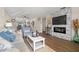 Bright living room with hardwood floors, modern fireplace, neutral colors, and beach-themed decor at 6070 80Th N St # 104, St Petersburg, FL 33709