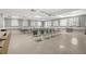 Well-lit meeting room with ample seating, tables, and a projector for presentations at 6070 80Th N St # 104, St Petersburg, FL 33709