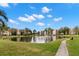 Scenic pond view surrounded by lush landscaping and condominium buildings at 6070 80Th N St # 104, St Petersburg, FL 33709