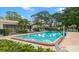 Refreshing community pool with lounge chairs and well-maintained landscaping, perfect for relaxation at 6070 80Th N St # 104, St Petersburg, FL 33709