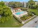 Aerial view of community pool with seating and shade at 6070 80Th N St # 104, St Petersburg, FL 33709