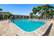 Community pool featuring brick patio and surrounding trees and lounge seating at 6070 80Th N St # 104, St Petersburg, FL 33709