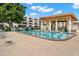 Outdoor community pool with shaded seating area on brick patio at 6070 80Th N St # 104, St Petersburg, FL 33709
