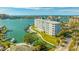 Breathtaking aerial view of condo complex with boat docks on the water and manicured landscaping at 610 Island Way # 302, Clearwater Beach, FL 33767