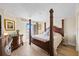 Elegant bedroom with four-poster bed, wood floors, and access to a balcony overlooking the water at 610 Island Way # 302, Clearwater Beach, FL 33767
